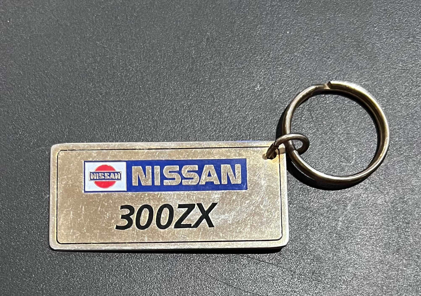 Nissan 300 ZX Gold Plated Metal Keychain with Engravable Backside NOS Relic has been store safely away for decades and shows some wear but vintage from the 1980s