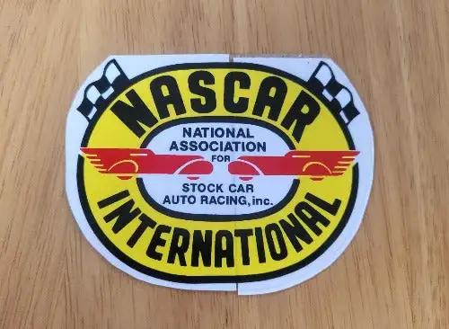NASCAR International Decal Cross Flags Auto Racing NOS item. This relic has been stored for decades and the oval measure 2.75 in in width x 3.5 in in length.