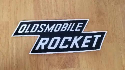 Oldsmobile Rocket Decal 1957-1958 Valve Cover Auto New Old Stock. This relic has been stored for decades and measures 2.75 inches in width by 8.25 inches in length.