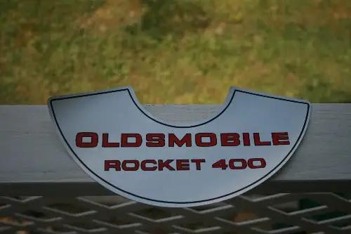 OLDSMOBILE ROCKET 400 DECAL AIR CLEANER LID MINT New Old Stock Item. Decal measuring 10 1/2 x 3 1/2 inches. Red lettering on a silver backing, mint condition!
