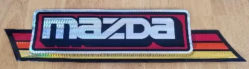 MAZDA 1970s Iridescent DECAL Bumper Sticker Vintage New Old Stock Turning back the clock big time with this adhesive decal. This relic measures approx 2.75 x 11.5 in