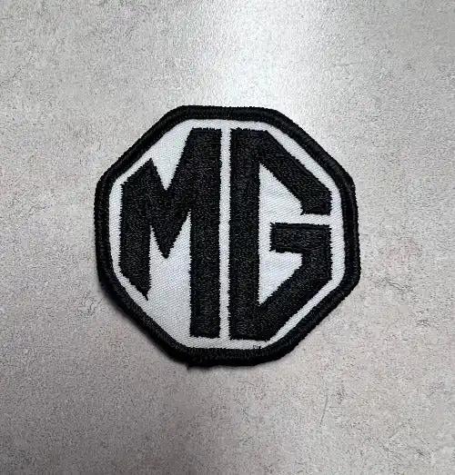 MG Patch Black Lettering and Border Octagonal Vintage Auto N.O.S.  EXC This relic has been stored for decades and measures 2 inch Octagon