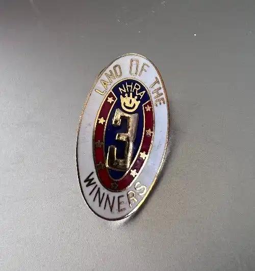 Land Of The Winners NHRA 3 Drag Racing Pin Crown Design Detailed Mint NOS This oval pin is approximately 1 inch long and .5 inch wide, painted on gold metal detailed