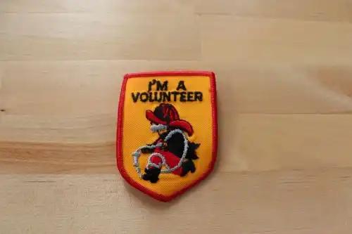 I'M A VOLUNTEER Fireman BADGE PATCH Character Unique Mint This is a 2 1/2 x 3 inch I'm A Volunteer patch with the Fireman logo.  Vintage mint condition, never sewn or displayed. patch PG Relics