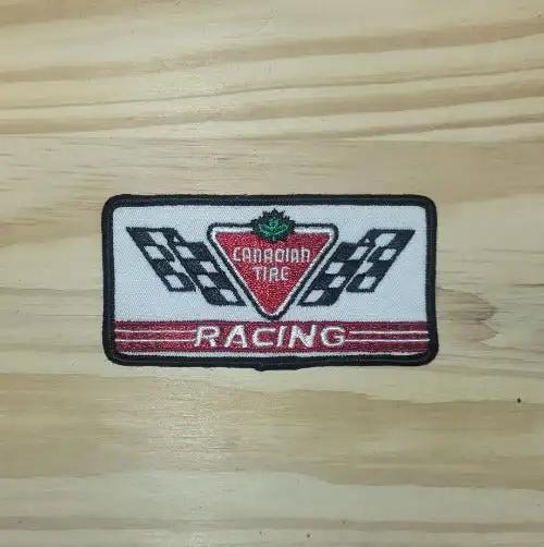 Canadian Tire Racing Patch Cross Flags Auto Rectangle N.O.S. Rare. This relic has been stored for decades and the oval measure 2 inch wide and the length is 4 inch
