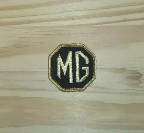 MG Patch Black and Gold Octagonal Vintage Auto N.O.S. Very Rare LOOK. This relic has been stored for decades and measures 2 inch Octagon. Great addition item to MG 