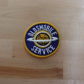 OLDSMOBILE Global SERVICE Vintage Auto PATCH NoS Mint New Old Stock OLDSMOBILE SERVICE patch with the Global Saturn ring.  We have a matching other Olds designs
