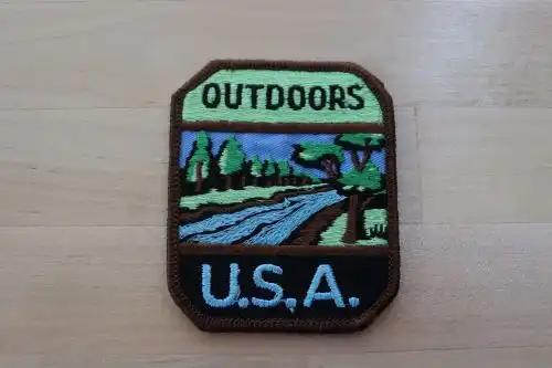 Camping Nature OUTDOORS USA Patch Vintage Trees Stream MINT NOS EXC measuring 3 x 3.5 in with great detailed stitching.  OUTDOORS U.S.A. nature camping hiking item