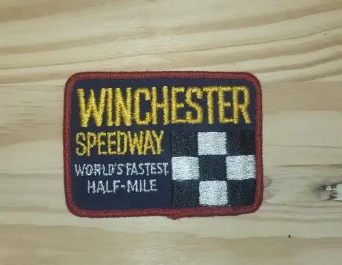 WINCHESTER SPEEDWAY Patch "WORLD'S FASTEST HALF-MILE" Cross Flags Auto Racing This relic has been stored for decades and the oval measure 2 x 4 inches. Great add!